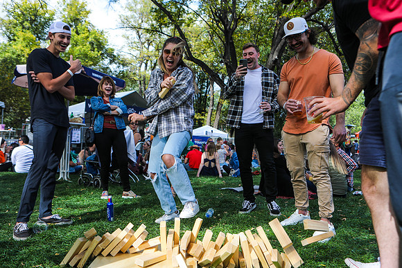 Friends Play a Game of Giant Jenga at Oktoberfest